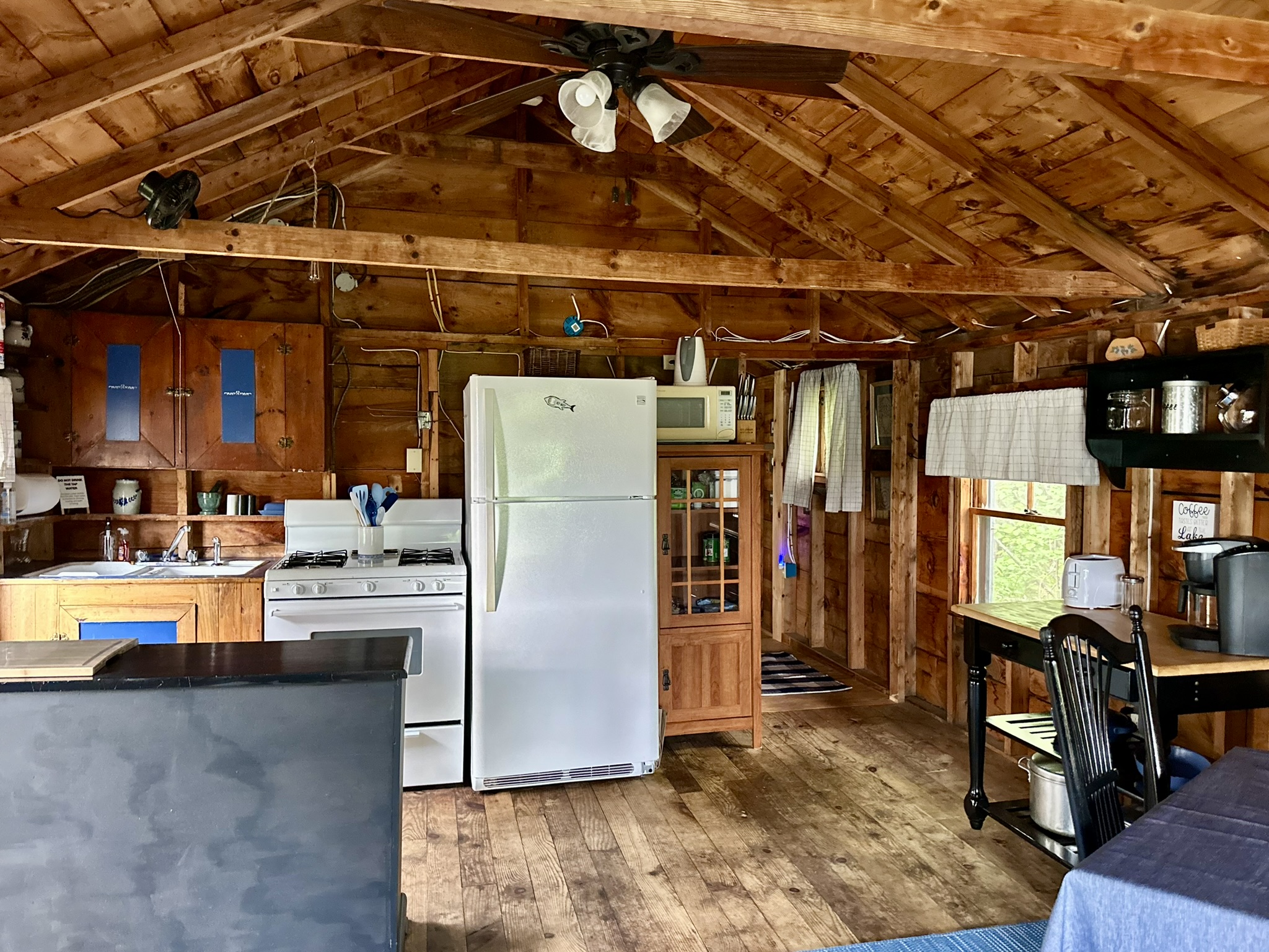 The dining room contains the kitchen, dining table and coffee station